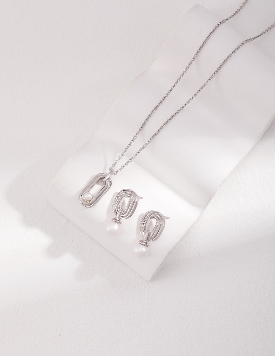 Sterling Silver Pearl Necklace with Twisted Möbius Oval Design